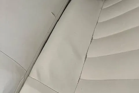 Slide: The Image of Close-up of 2005 Cobalt 282 boat seat with visible seam tear. - 18