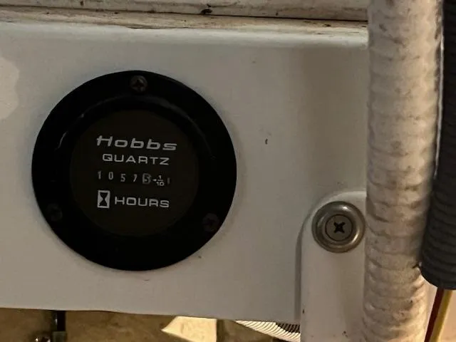 Slide: The Image of Hobbs Quartz hour meter on 2005 Cobalt 282 boat, displaying 1057.5 hours. - 5
