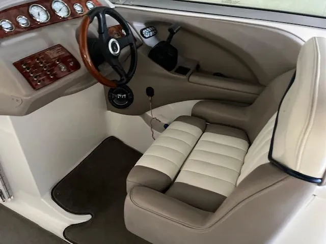 Slide: The Image of 2005 Cobalt 282 boat cockpit with steering wheel and control panel. - 8