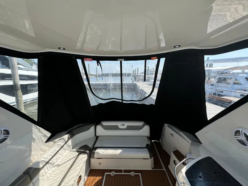 Slide: The Image of 2014 Monterey 340 Sport Yacht interior with seating and wood flooring. - 11