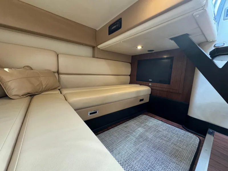 Slide: The Image of Luxurious interior of 2014 Monterey 340 Sport Yacht with beige seating and TV. - 17