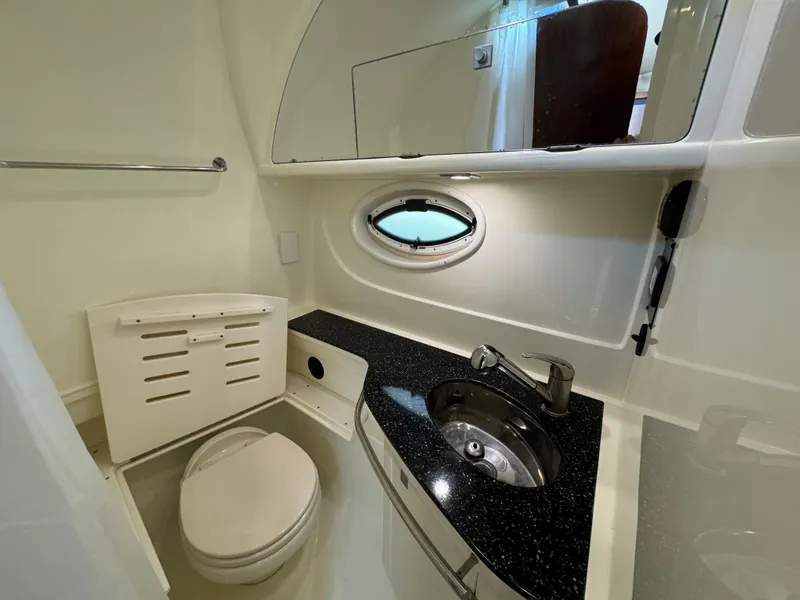 Slide: The Image of 2014 Monterey 340 Sport Yacht bathroom with modern fixtures and oval window. - 19