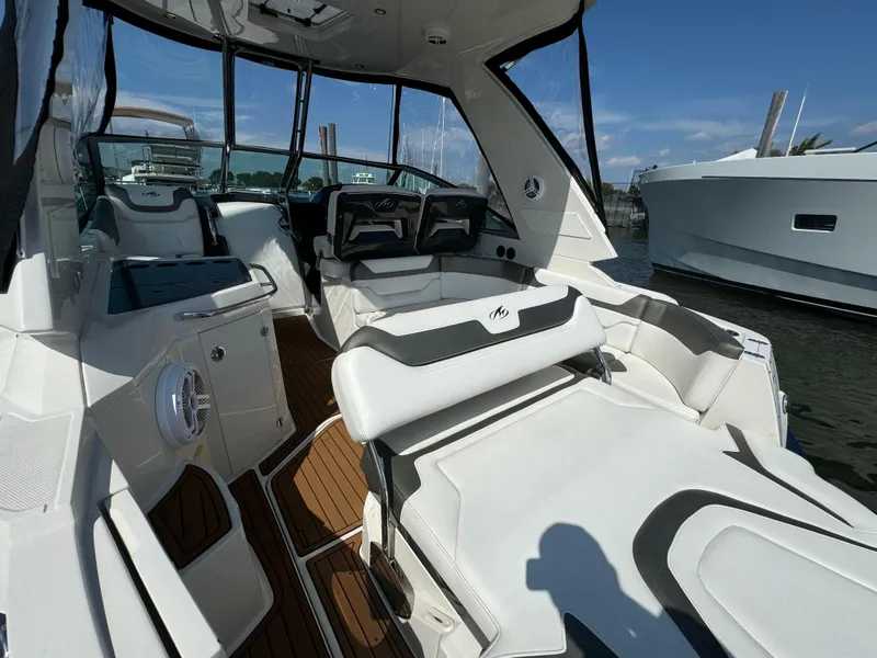 Slide: The Image of 2014 Monterey 340 Sport Yacht interior with white seating and wood flooring. - 2
