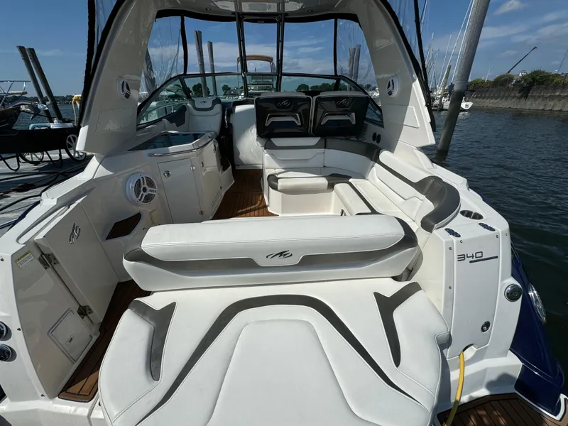 Slide: The Image of 2014 Monterey 340 Sport Yacht interior with white seating, docked at marina. - 3