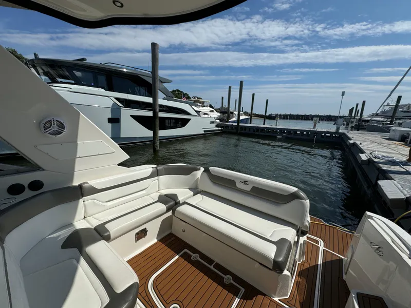 Slide: The Image of 2014 Monterey 340 Sport Yacht at marina, featuring spacious seating and elegant design. - 5