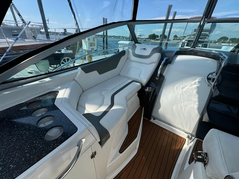 Slide: The Image of 2014 Monterey 340 Sport Yacht interior with white seating and wood flooring. - 8