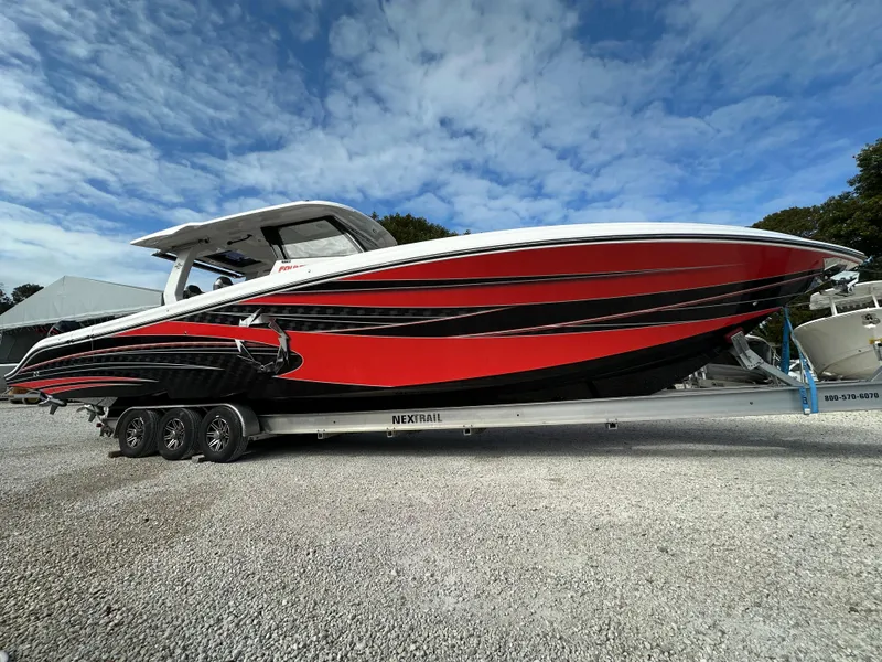 Slide: The Image of 2024 Fountain 43SCX boat with red and black design on a trailer. - 0