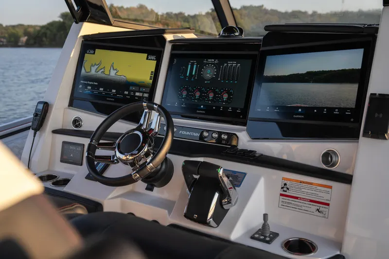 Slide: The Image of 2024 Fountain 43SCX boat dashboard with advanced navigation displays and controls. - 16