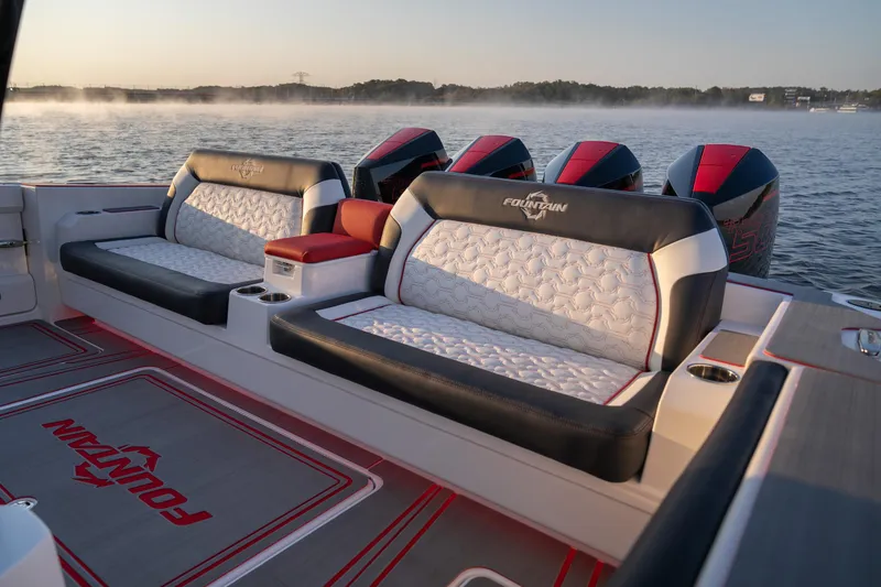 Slide: The Image of 2024 Fountain 43SCX boat interior with luxurious seating and multiple engines on a serene lake. - 18