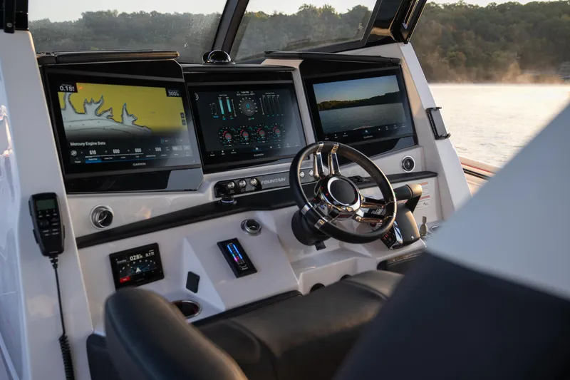 Slide: The Image of 2024 Fountain 43SCX boat dashboard with advanced navigation screens and controls. - 19