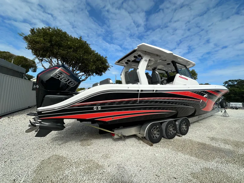 Slide: The Image of 2024 Fountain 43SCX boat with sleek design, triple engines, and vibrant red accents. - 2