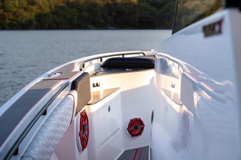 Slide: The Image of 2024 Fountain 43SCX boat interior with sleek design and red accents on a calm lake. - 21