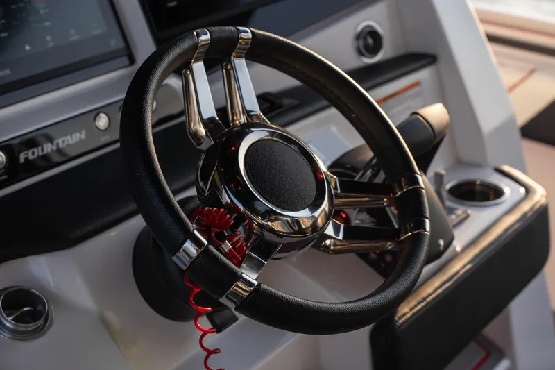 Slide: The Image of Steering wheel of 2024 Fountain 43SCX boat, featuring sleek design and modern controls. - 25