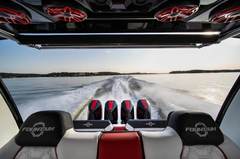 Slide: The Image of 2024 Fountain 43SCX boat interior with powerful engines on a serene lake. - 28