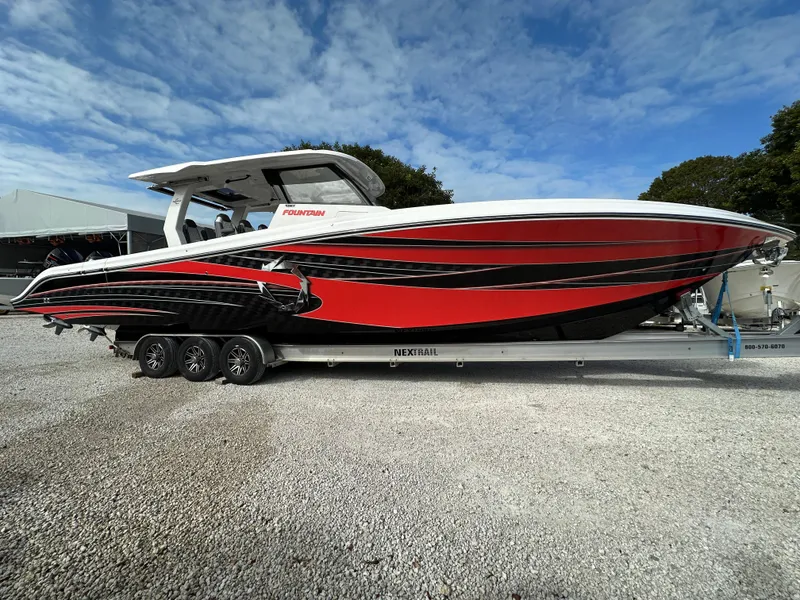 Slide: The Image of 2024 Fountain 43SCX boat with red and black design on a trailer. - 4