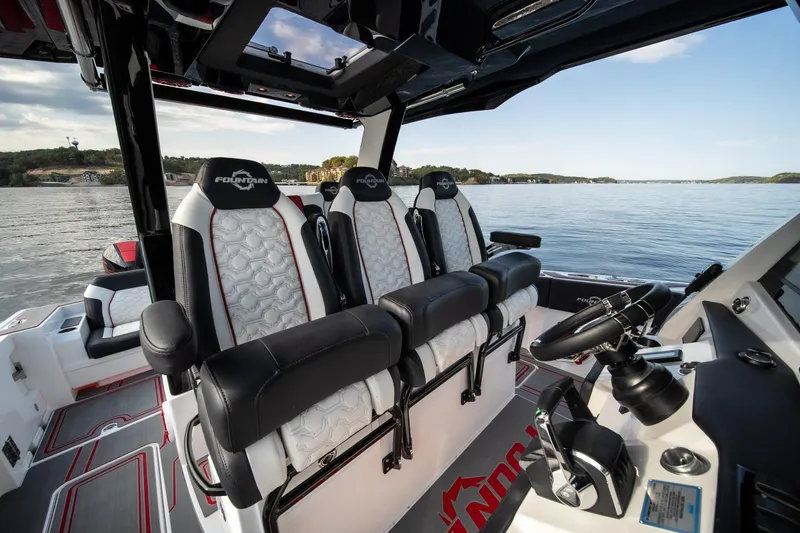 Slide: The Image of 2024 Fountain 43SCX boat interior with luxury seating on a calm lake. - 43