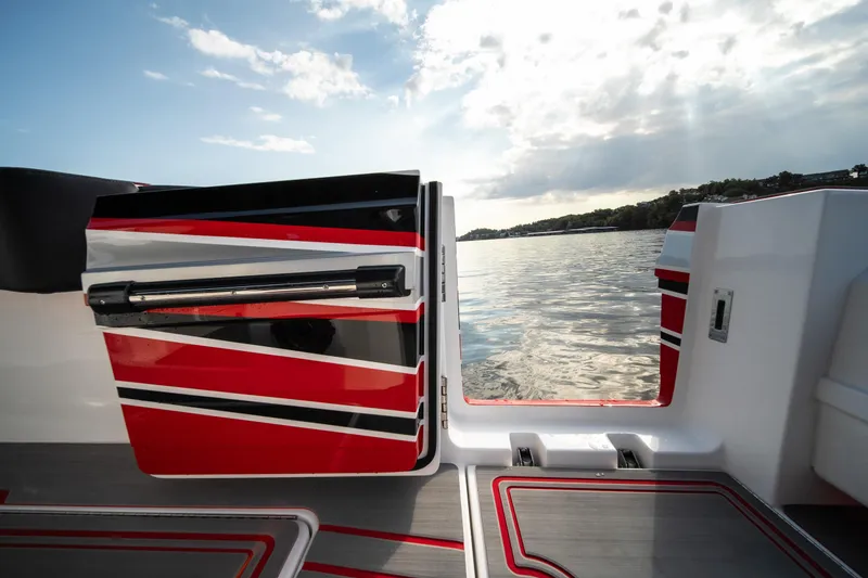 Slide: The Image of 2024 Fountain 43SCX boat with red and black design, open door to scenic water view. - 45