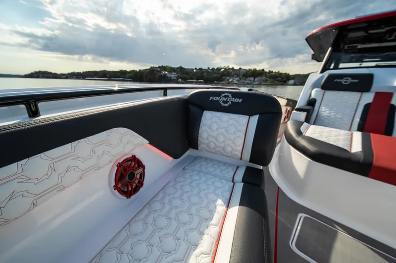 Slide: The Image of 2024 Fountain 43SCX boat interior with stylish seating and speaker, scenic water view. - 47