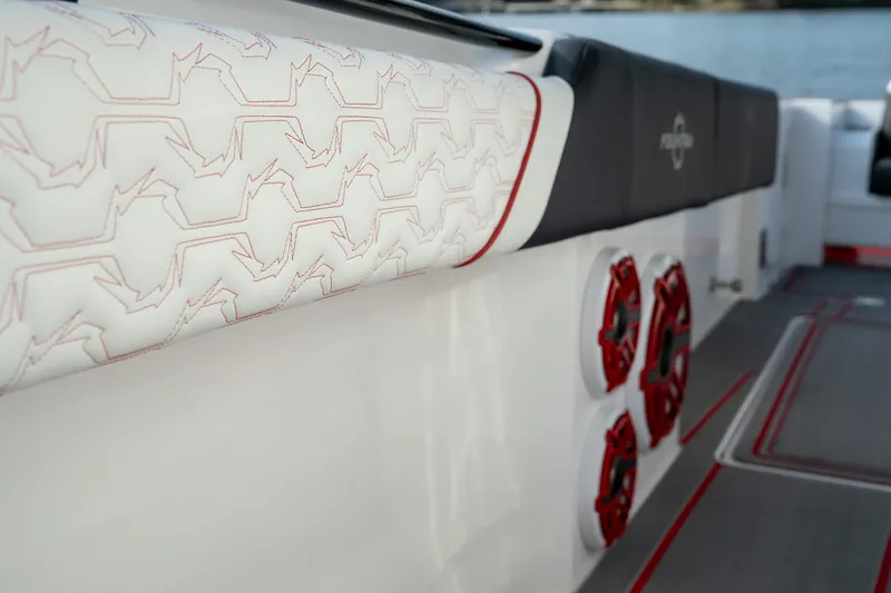 Slide: The Image of 2024 Fountain 43SCX boat interior with stylish seating and red-accented speakers. - 49