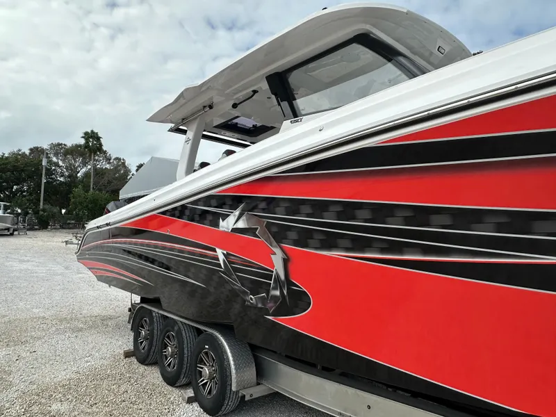 Slide: The Image of 2024 Fountain 43SCX boat with striking red and black design on a trailer. - 6
