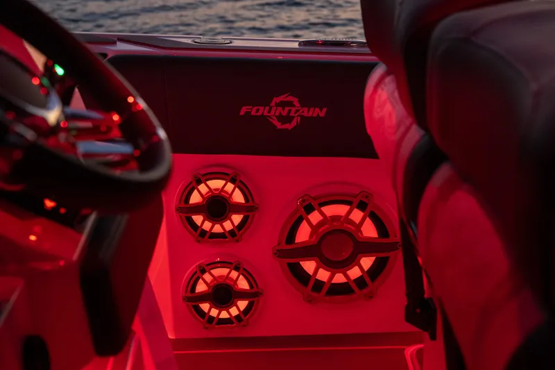 Slide: The Image of 2024 Fountain 43SCX boat interior with illuminated speakers and steering wheel. - 66