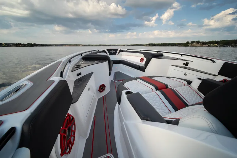 Slide: The Image of 2024 Fountain 43SCX boat interior with sleek seating and modern design on a calm lake. - 7