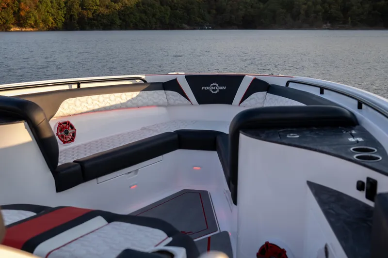 Slide: The Image of 2024 Fountain 43SCX boat interior with luxurious seating on a serene lake. - 8