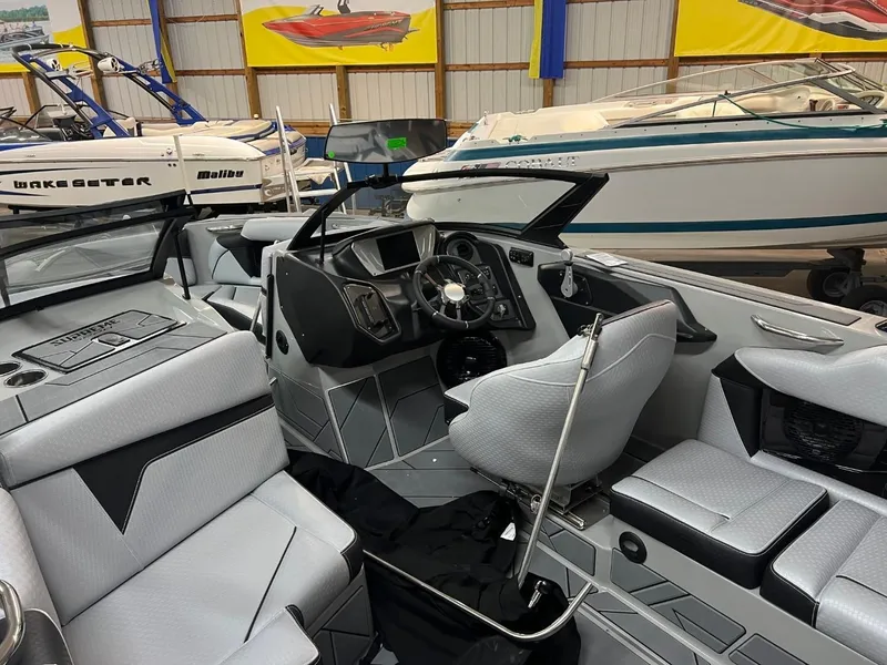 Slide: The Image of 2024 Supreme S220 boat interior with modern dashboard and seating. - 13
