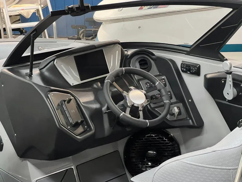Slide: The Image of 2024 Supreme S220 boat dashboard with modern controls and steering wheel. - 14
