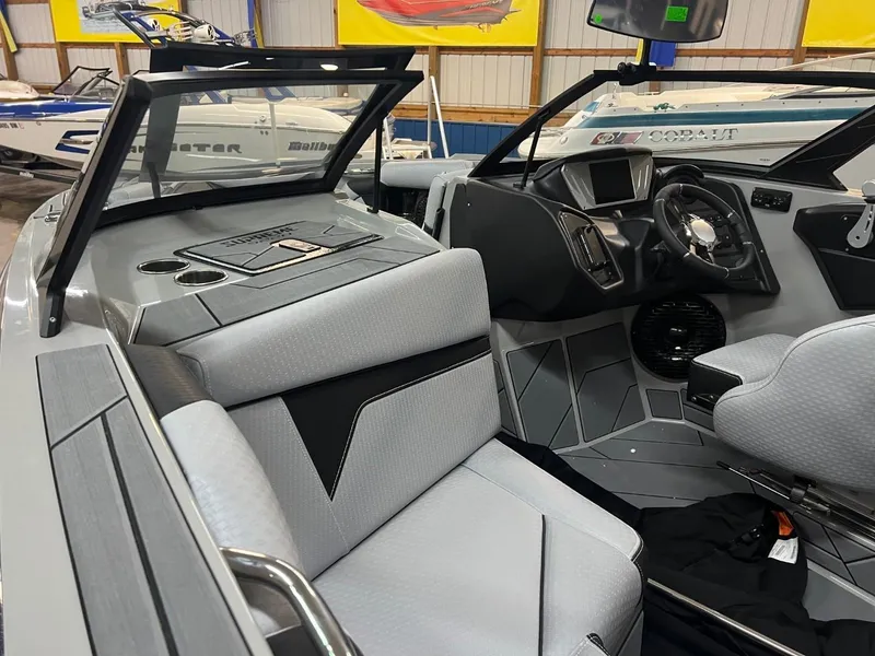 Slide: The Image of 2024 Supreme S220 boat interior with modern dashboard and seating. - 15