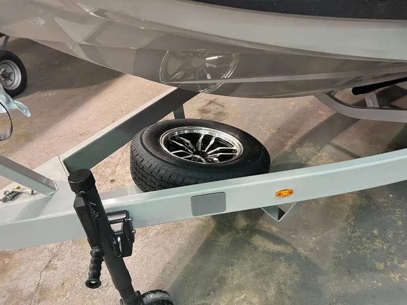 Slide: The Image of 2024 Supreme S220 boat trailer with spare tire and sleek design. - 19