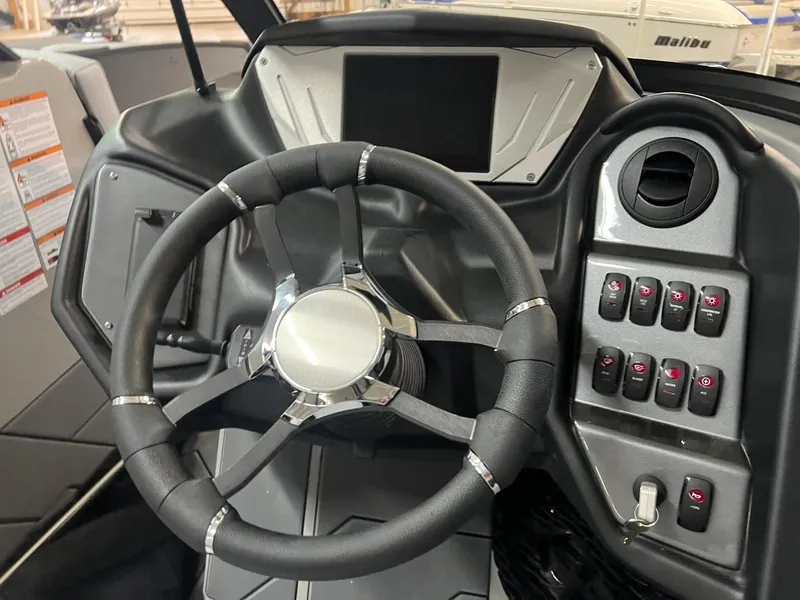 Slide: The Image of 2024 Supreme S220 boat dashboard with steering wheel and control panel. - 22