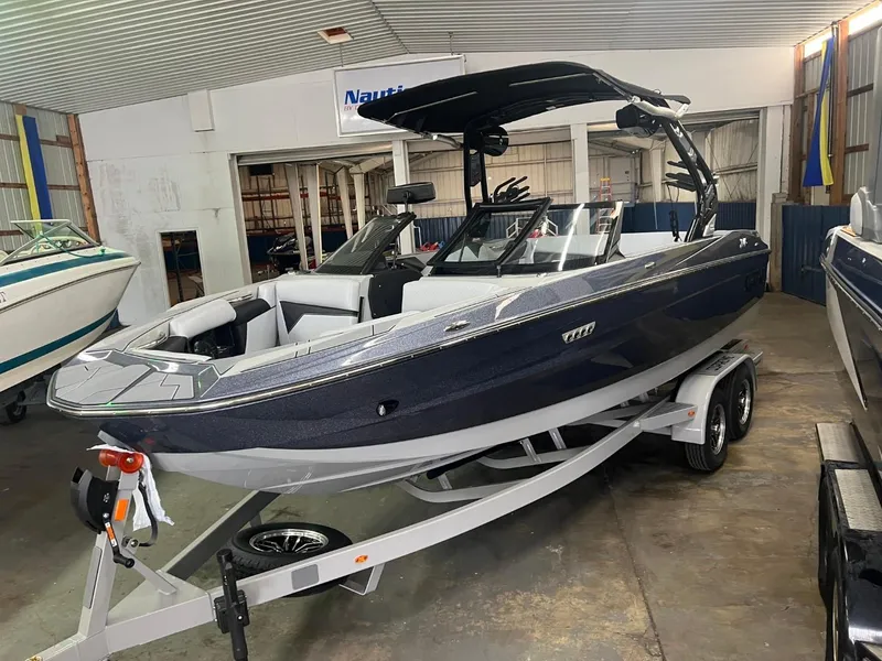 Slide: The Image of 2024 Supreme S220 boat on trailer in indoor showroom. - 25