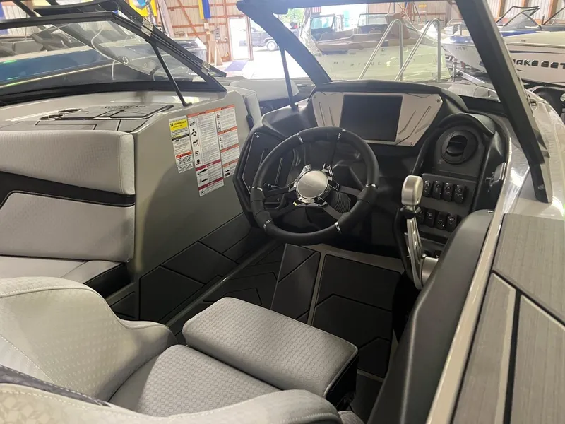 Slide: The Image of 2024 Supreme S220 boat interior with modern steering and dashboard controls. - 29