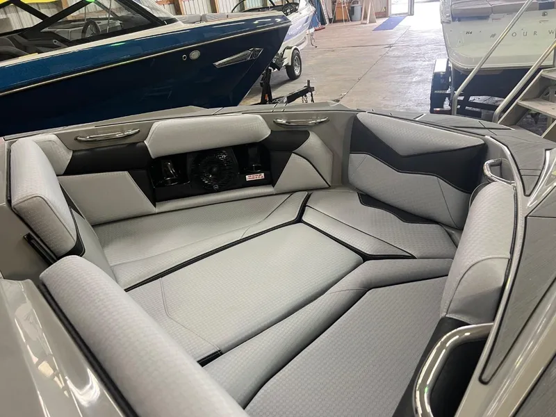 Slide: The Image of 2024 Supreme S220 boat interior with sleek gray seating and modern design. - 30