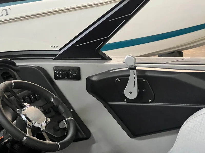 Slide: The Image of Interior of 2024 Supreme S220 boat, featuring steering wheel and control panel. - 40