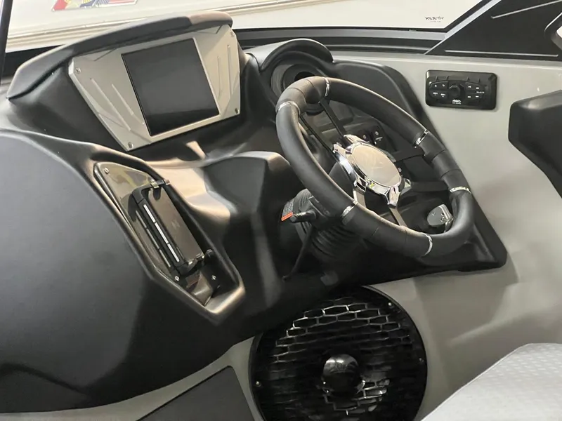 Slide: The Image of 2024 Supreme S220 boat dashboard with steering wheel and digital display. - 41