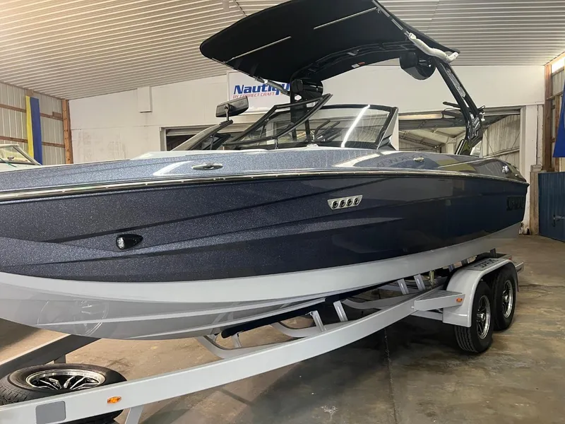 Slide: The Image of 2024 Supreme S220 boat on trailer in indoor storage facility. - 42