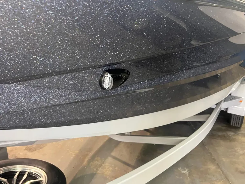 Slide: The Image of 2024 Supreme S220 boat hull with metallic finish on trailer. - 44