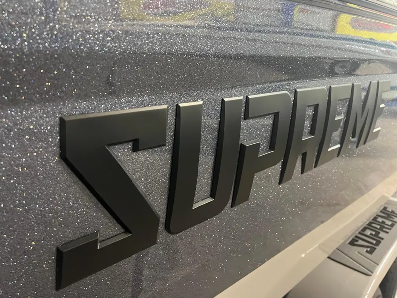 Slide: The Image of Close-up of 2024 Supreme S220 logo on a glittery surface. - 47
