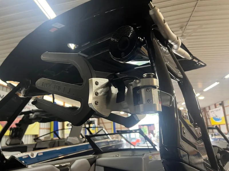 Slide: The Image of 2024 Supreme S220 boat with wakeboard rack in a showroom. - 49