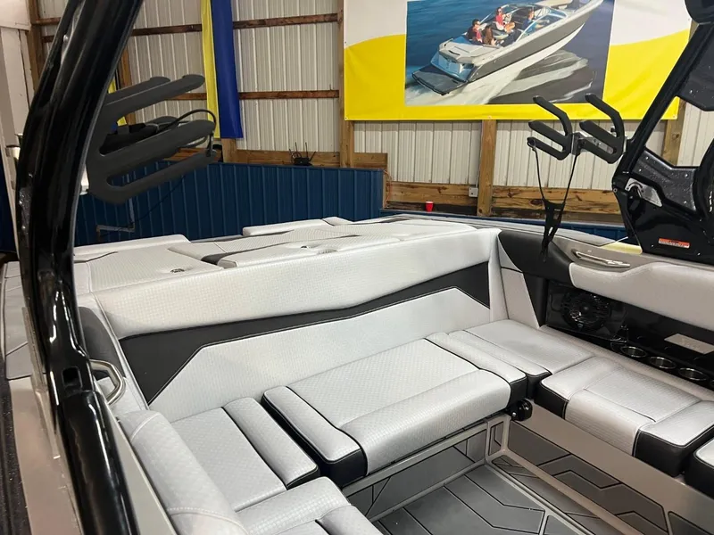 Slide: The Image of 2024 Supreme S220 boat interior with sleek white seating and modern design. - 7