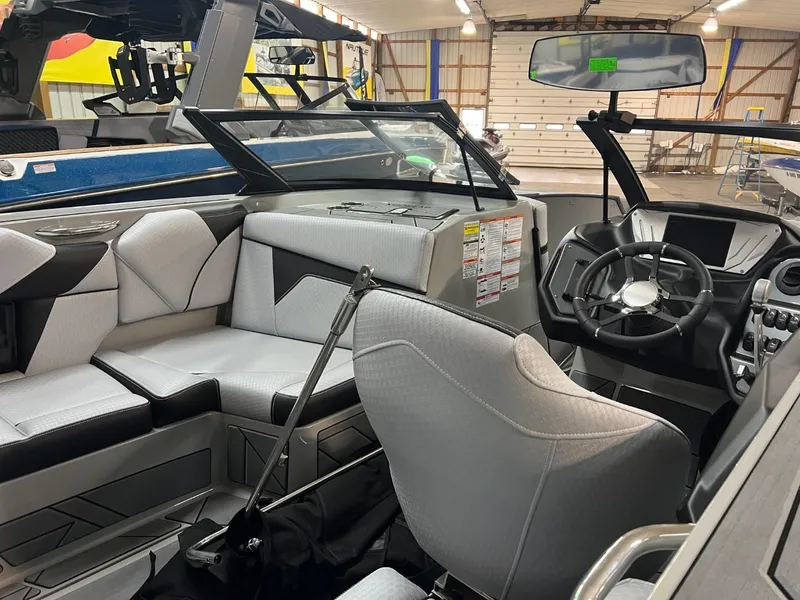 Slide: The Image of 2024 Supreme S220 boat interior with modern seating and steering wheel. - 8
