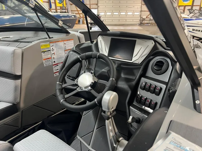 Slide: The Image of 2024 Supreme S220 boat dashboard with steering wheel and control panel. - 9