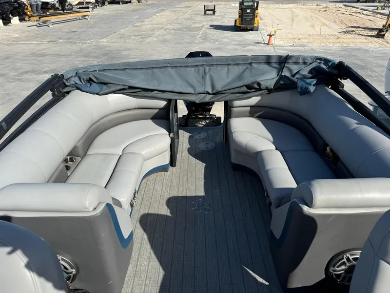 Slide: The Image of 2022 Manitou 23' Oasis RFSHP373 pontoon boat with gray seating and covered helm. - 13