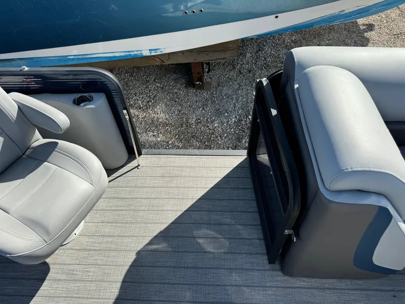 Slide: The Image of 2022 Manitou 23' Oasis RFSHP373 boat interior with gray seating and flooring. - 16