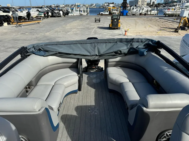 Slide: The Image of 2022 Manitou 23' Oasis RFSHP373 pontoon boat with gray seating at a marina. - 6