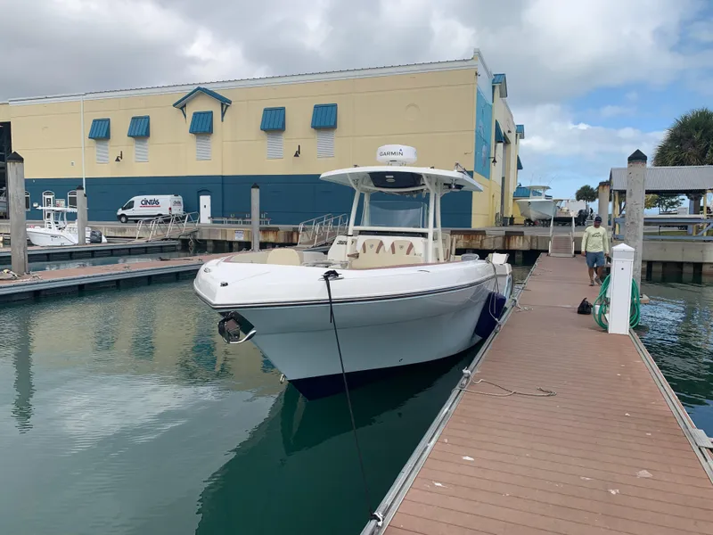 Slide: The Image of 2019 Century 3200 Center Console boat docked at marina. - 2