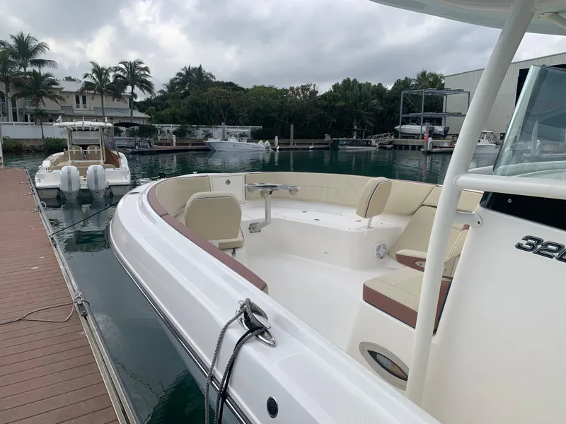 Slide: The Image of 2019 Century 3200 Center Console boat docked at marina with seating area. - 4