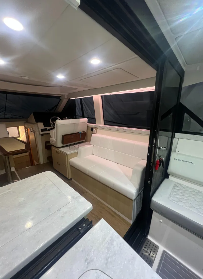 Slide: The Image of Interior of 2023 Regal 38 XO yacht with modern seating and sleek design. - 10